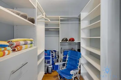 a walk in closet with a blue chair and shelves at Beach Paradise, Family - Friendly, Free Parking in Hollywood
