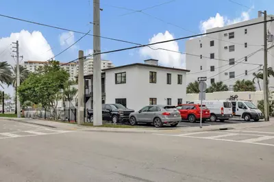 a parking lot with cars parked in front of a building at Studio Right off Las Olas - Steps to FTL Beach 1C in Fort Lauderdale