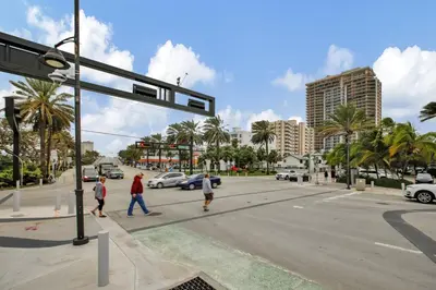 a group of people crossing the street at an intersection at Studio Right off Las Olas - Steps to FTL Beach 1C in Fort Lauderdale