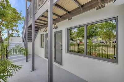 an exterior view of a building with large windows at 2 Condo Combo Walk to Beach Off Las Olas 2AB in Fort Lauderdale