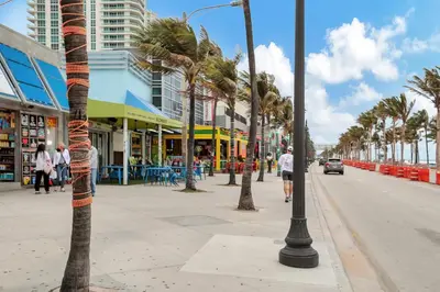 a street with palm trees on a city street at 2 Condo Combo - Walk to Beach Off Las Olas 1AB in Fort Lauderdale