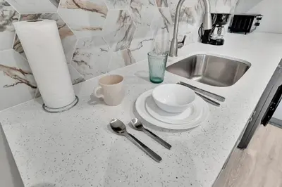 a kitchen counter with a sink and a plate and spoon at Studio Right off Las Olas - Steps to FTL Beach 2C in Fort Lauderdale