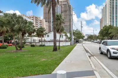 a street with palm trees on the side of a road at Studio Right off Las Olas - Steps to FTL Beach 2C in Fort Lauderdale