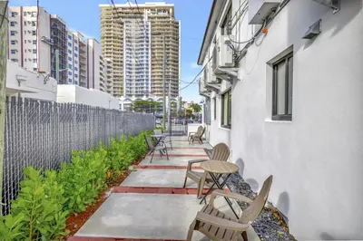 a patio with chairs and tables on a building at Studio Right off Las Olas - Steps to FTL Beach 2B in Fort Lauderdale