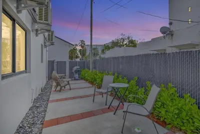a patio with chairs and a table and a fence at Studio Right off Las Olas - Steps to FTL Beach 1B in Fort Lauderdale