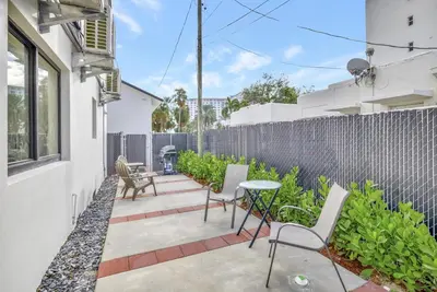 a patio with chairs and a table and a fence at Studio Right off Las Olas - Steps to FTL Beach 1B in Fort Lauderdale