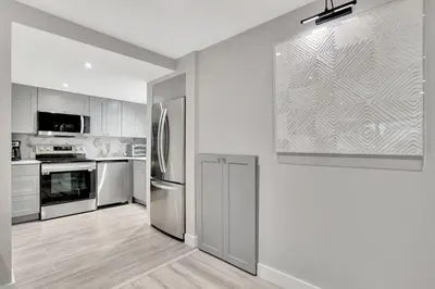 a kitchen with stainless steel appliances and white cabinets at Lux Villa 3br 2ba off Las Olas in Fort Lauderdale