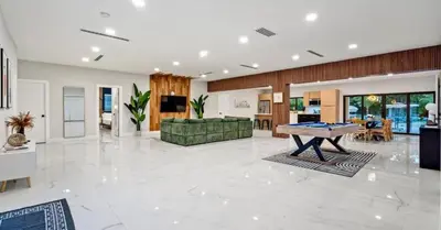 a large living room with a pool table in it at Sunny Isles Beach Luxury Property by Glam Homes in Miami