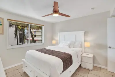 a bedroom with a white bed and a window at Beach Condo - Hollywood Beachfront and Broadwalk in Hollywood