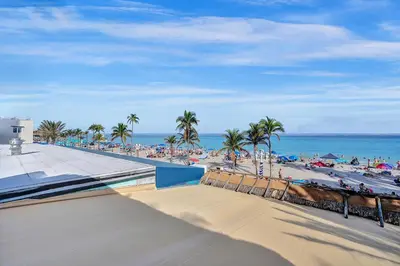 a view of a beach with palm trees and the ocean at Beach Efficiency - Hollywood Beachfront and Broadwalk in Hollywood
