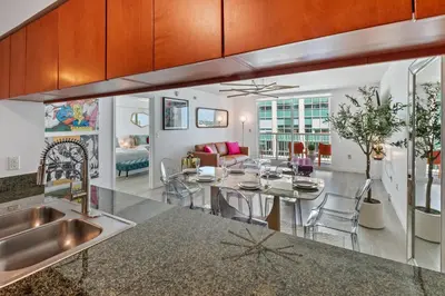 a kitchen and living room with a table and chairs at Oceanside Penthouse Apartment in Brickell Miami, Pool, Free Parking in Miami