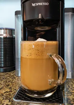 a glass mug of coffee sitting on a counter at Oceanside Penthouse Apartment in Brickell Miami, Pool, Free Parking in Miami