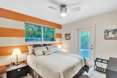 a bedroom with a large bed and a window at Heated pool, parking, 5 min walk to food and fun! in Fort Lauderdale