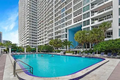 a large swimming pool in front of a large building at Shades of Miami Sky Penthouse! Newly Renovated in Miami