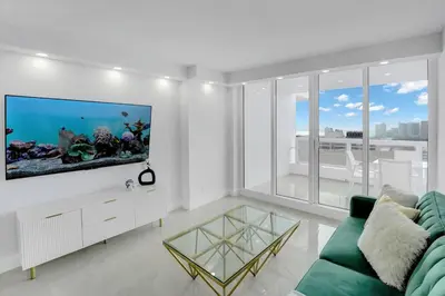 a living room with a fish tank on the wall at Shades of Miami Sky Penthouse! Newly Renovated in Miami