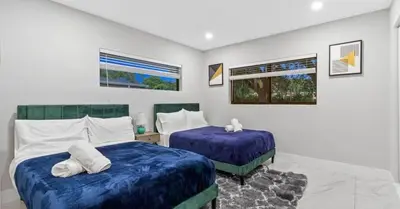 a bedroom with two beds with blue sheets at Entertaining Villa Fun Games Mini Golf Grill in Miami