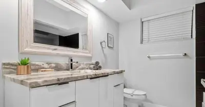 a bathroom with a sink and a mirror at Entertaining Villa Fun Games Mini Golf Grill in Miami