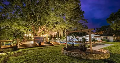 a home with a yard at night with lights at New Hidden Gem in Miami