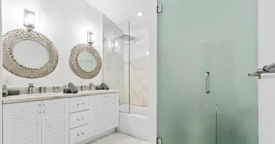 a bathroom with a shower and a sink and mirror at New Hidden Gem in Miami