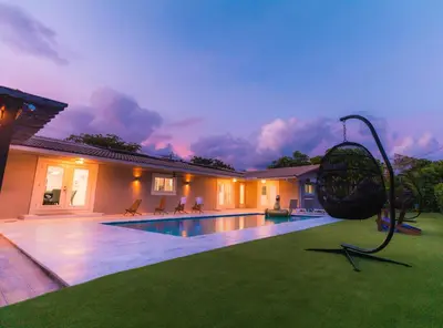 a villa with a swimming pool and a house at Villa w/a Huge Terrace & Grill Mini Golf Pool in Miami