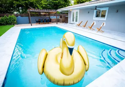 a yellow inflatable rubber duck in a swimming pool at Villa w/a Huge Terrace & Grill Mini Golf Pool in Miami
