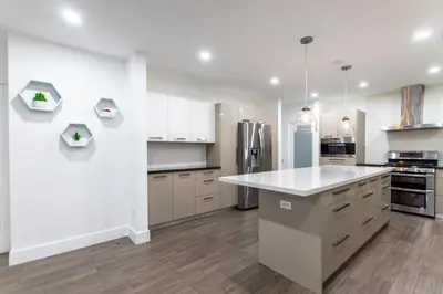 a kitchen with white cabinets and a white counter top at Villa w/a Huge Terrace & Grill Mini Golf Pool in Miami