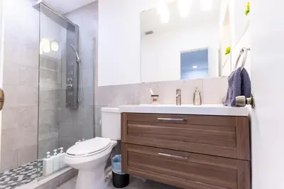 a bathroom with a toilet and a sink and a shower at Villa w/a Huge Terrace & Grill Mini Golf Pool in Miami