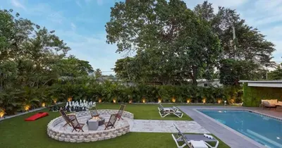 a backyard with a pool and a fire pit next to a swimming pool at Villa Athena - The Glamhomes in Miami