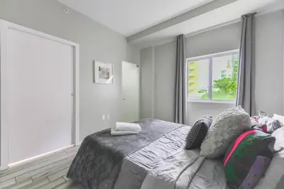 a white bedroom with a bed and a window at Wynwood Amazing Condo Sleeps 5 Close to Beach in Miami