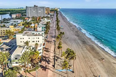 an aerial view of a beach with palm trees and buildings at Panoramic beachfront Suite in Hollywood
