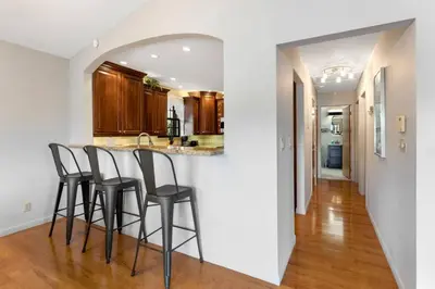 a kitchen with a bar with stools in it at DOWNTOWN LAS OLAS WATERFRONT HOME UPDATED UNIT in Fort Lauderdale