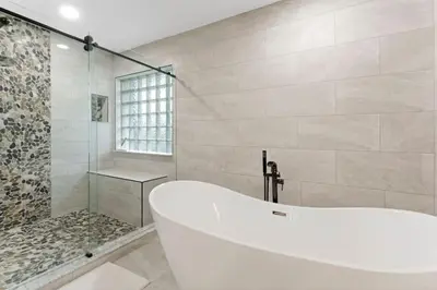 a white tub in a bathroom with a shower at DOWNTOWN LAS OLAS WATERFRONT HOME UPDATED UNIT in Fort Lauderdale