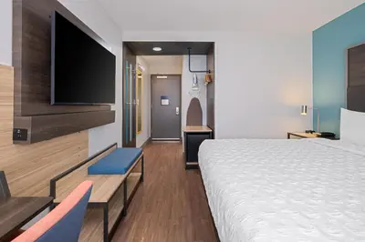 a hotel room with a bed and a flat screen tv at Tru By Hilton Miramar in Miramar