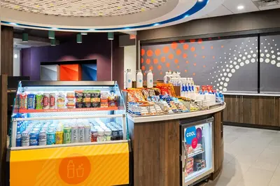 a store with a drink counter and a refrigerator at Tru By Hilton Miramar in Miramar