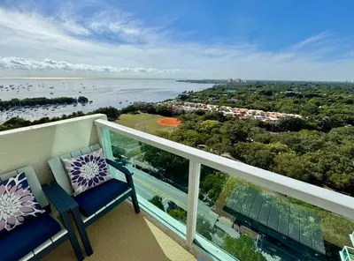 a balcony with two chairs and a view of the water at Balcony Ocean View ! Pool - WiFi - Gym - Parking in Miami