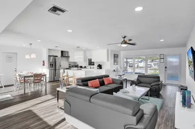 a living room and kitchen with a couch and a table at Gorgeous poolhome on the canal in Fort Lauderdale