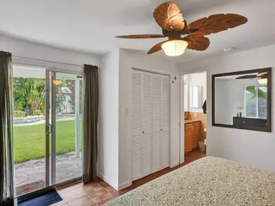 a bedroom with a bed and a ceiling fan at 3 min. walk to Wilton Drive, pool and huge yard in Fort Lauderdale