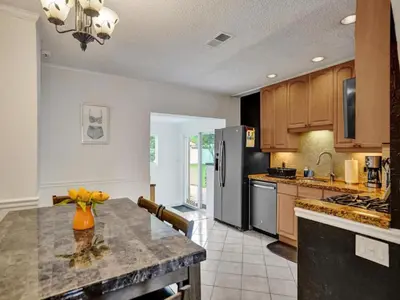 a kitchen with a counter top and a refrigerator at 3 min. walk to Wilton Drive, pool and huge yard in Fort Lauderdale