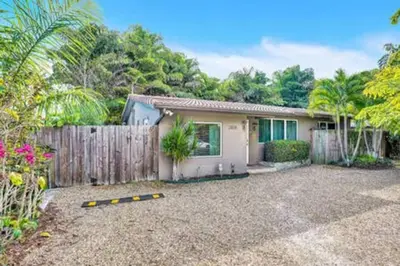 a house with a fence and a yard at Private studio, 5 min. walk to Wilton Drive in Fort Lauderdale