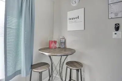a small table with two stools in a room at Private studio, 5 min. walk to Wilton Drive in Fort Lauderdale