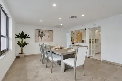 a kitchen and dining room with a table and chairs at Ocean View 2BD Penthouse Beach Service PH-6 in Miami Beach