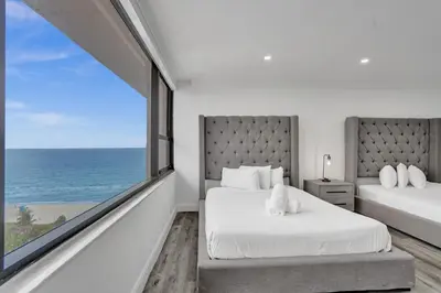 a bedroom with two beds and a large window at Ocean View 2BD Penthouse Beach Service PH-6 in Miami Beach