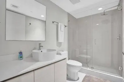 a bathroom with a toilet and a sink and a shower at Spacious Luxury Ocean View 4 Bdrs 3Baths 17 FL in Hallandale Beach