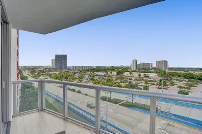 a balcony with a view of a parking lot at Awesome Ocean View Modern Condo Pool Shuttle in Hallandale Beach