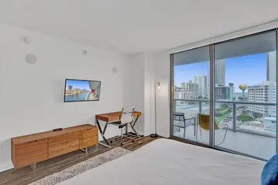 a white room with a desk and a desk at Awesome Ocean View Modern Condo Pool Shuttle in Hallandale Beach