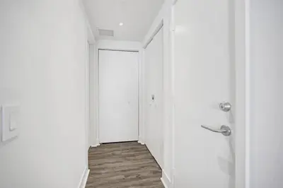 an empty hallway with a white door and a wooden floor at Luxury 2BR 2BA Water Front in Hyde Beach Resort in Hollywood