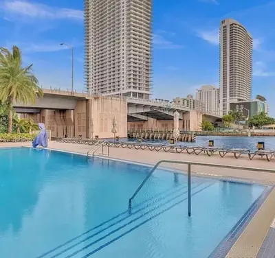 a large swimming pool in a city with tall buildings at Upscale Resort 4 Bedrooms 3 bath in Hallandale Beach