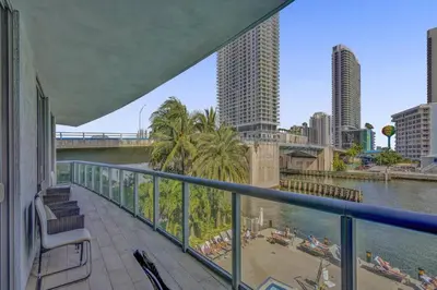 a balcony with a view of a river and a city at Upscale Resort 4 Bedrooms 3 bath in Hallandale Beach