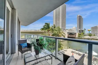 a balcony with furniture and a view of the city at Upscale Resort 4 Bedrooms 3 bath in Hallandale Beach