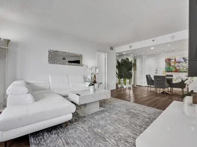 a living room with a white couch and a table at Adorable 2 Bedroom Condo Beach Service 605 in Miami Beach